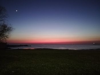Scenic view of sea against clear sky during sunset