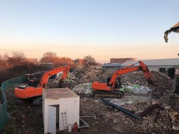 Construction site against clear sky during sunset