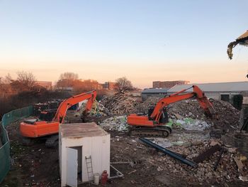 Construction site against clear sky during sunset