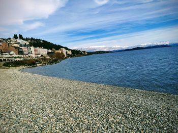 Scenic view of beach against sky in city