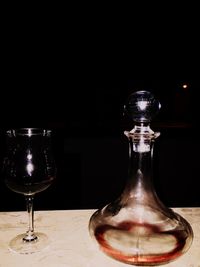 Close-up of wineglass against black background