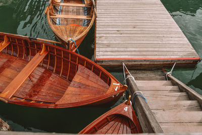 High angle view of boats moored by pier over lake