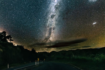 Scenic view of road against sky at night