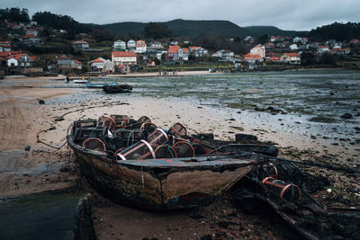 Abandoned boat moored on beach