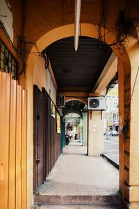 Empty alley amidst buildings in city
