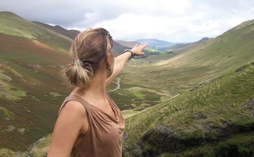 Woman standing against mountains