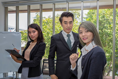 Portrait of business people standing in office