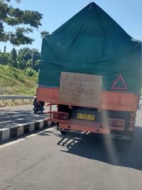 Information sign on road against sky