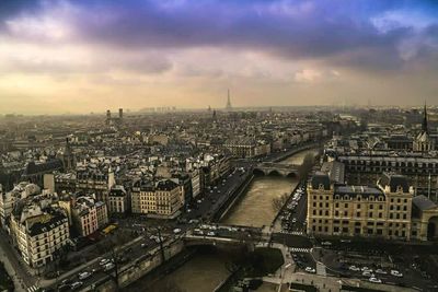 Cityscape against cloudy sky