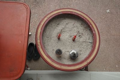 High angle view of red wine in container on street