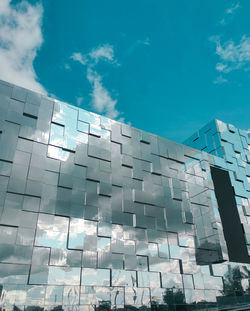 Low angle view of modern building against blue sky