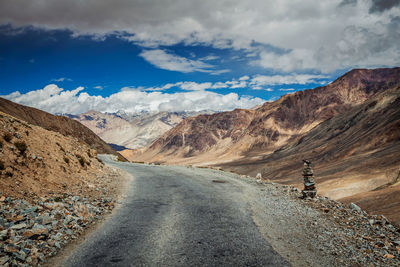 Road amidst mountains against sky