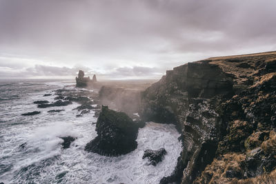 Scenic view of sea against cloudy sky