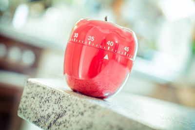 Close-up of apple shape dial on table