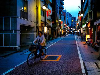 People riding bicycle on city street