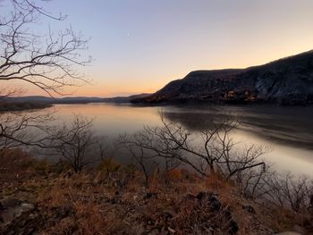 Scenic view of lake against sky during sunset