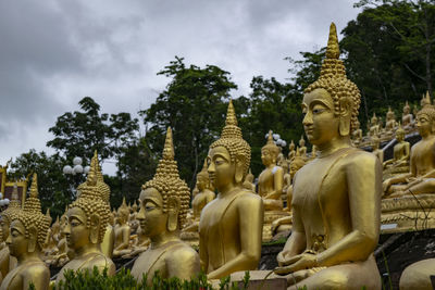 Panoramic view of statues on temple outside building against sky