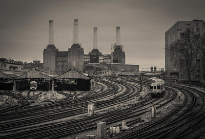 Railroad tracks by battersea power station against sky