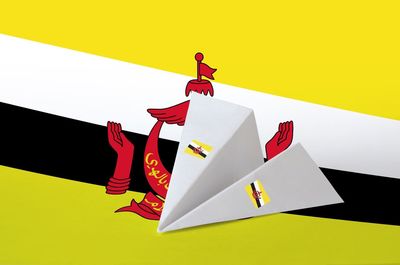 High angle view of paper flag on table against yellow background