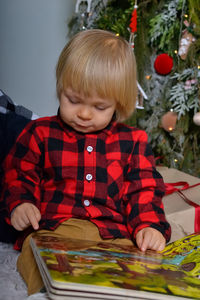 Portrait of cute girl playing with toy blocks at home