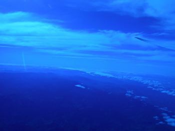 Aerial view of sea against blue sky