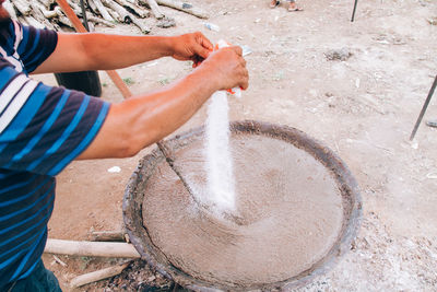 Midsection of man preparing food