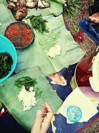 High angle view of woman and vegetables on table