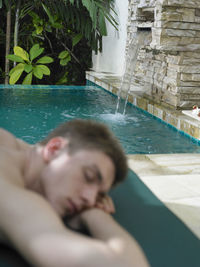 Young woman relaxing in swimming pool