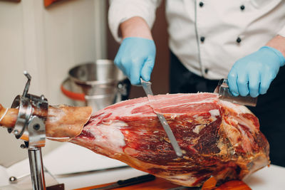 Midsection of man preparing food in kitchen