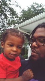 Portrait of a smiling young man with father