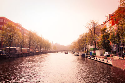 River passing through city against clear sky