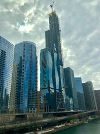 Low angle view of buildings against cloudy sky