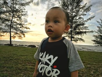 Portrait of cute boy standing on field