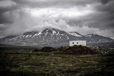 Scenic view of mountains against cloudy sky