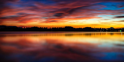 Scenic view of lake against romantic sky at sunset