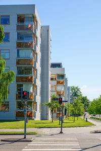 Street amidst buildings against clear blue sky