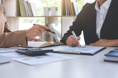 Close-up of business colleagues working in office