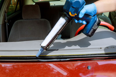 Cropped image of person repairing car