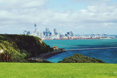 Scenic view of buildings against cloudy sky