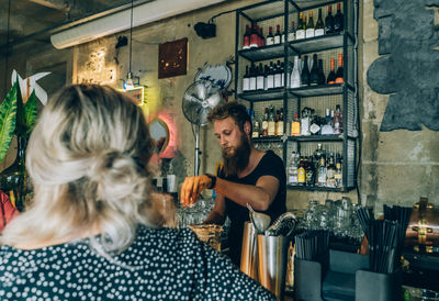 Girl and bartender in a cocktail bar.
