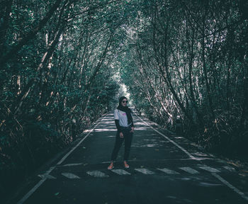 Woman walking on footpath in forest