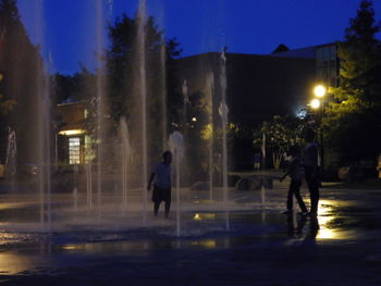 Illuminated fountain at night