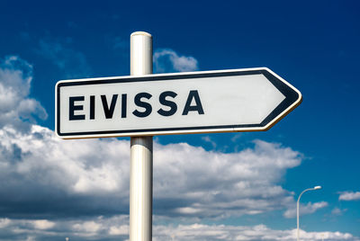 Low angle view of road sign against sky