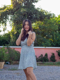 A asian nationality thai woman wearing blue dress and feel good