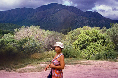 Full length of man standing on landscape against mountains