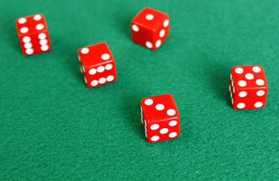 High angle view of red dice on green table