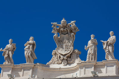 Low angle view of statue against blue sky