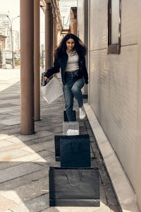 Happy young woman rejoices in good shopping. girl with shopping bags.