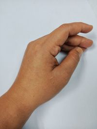 Close-up of person hand over white background