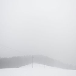 Snow covered trees against sky